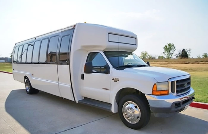 White 32 passenger Ford shuttle bus.