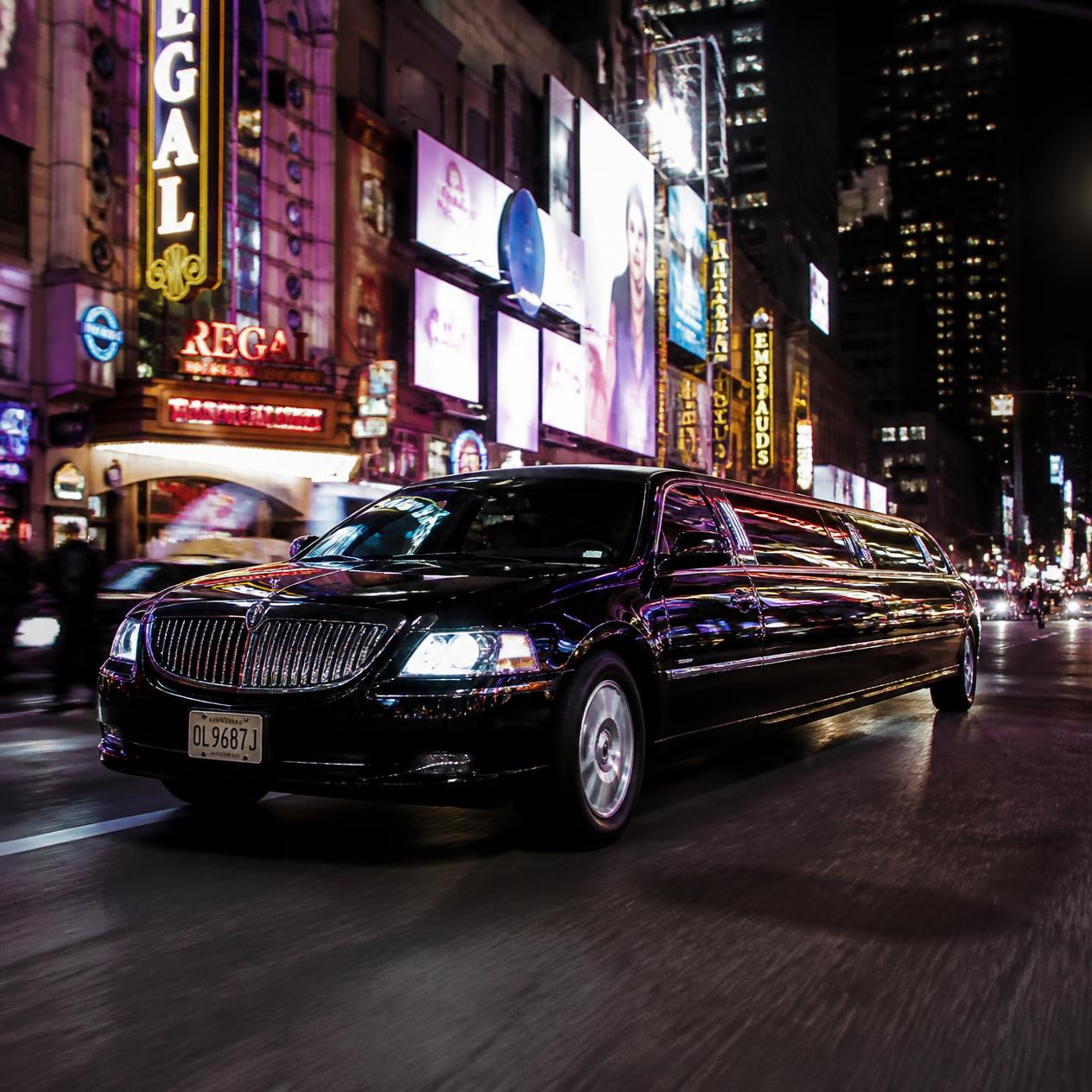 Hourly limo service vehicle on a Washington DC road at night