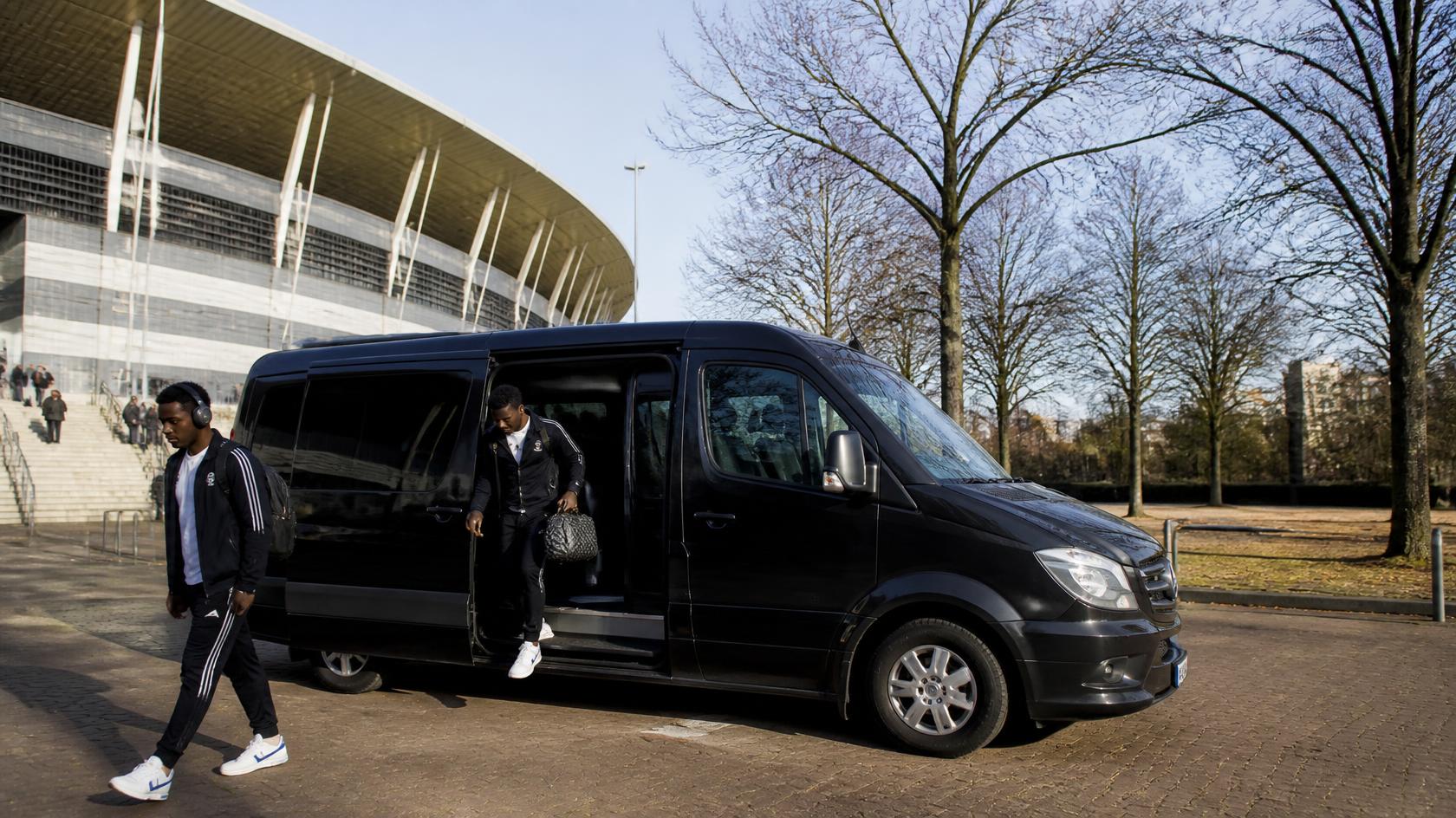 Employees boarding a corporate shuttle on a scheduled daily route