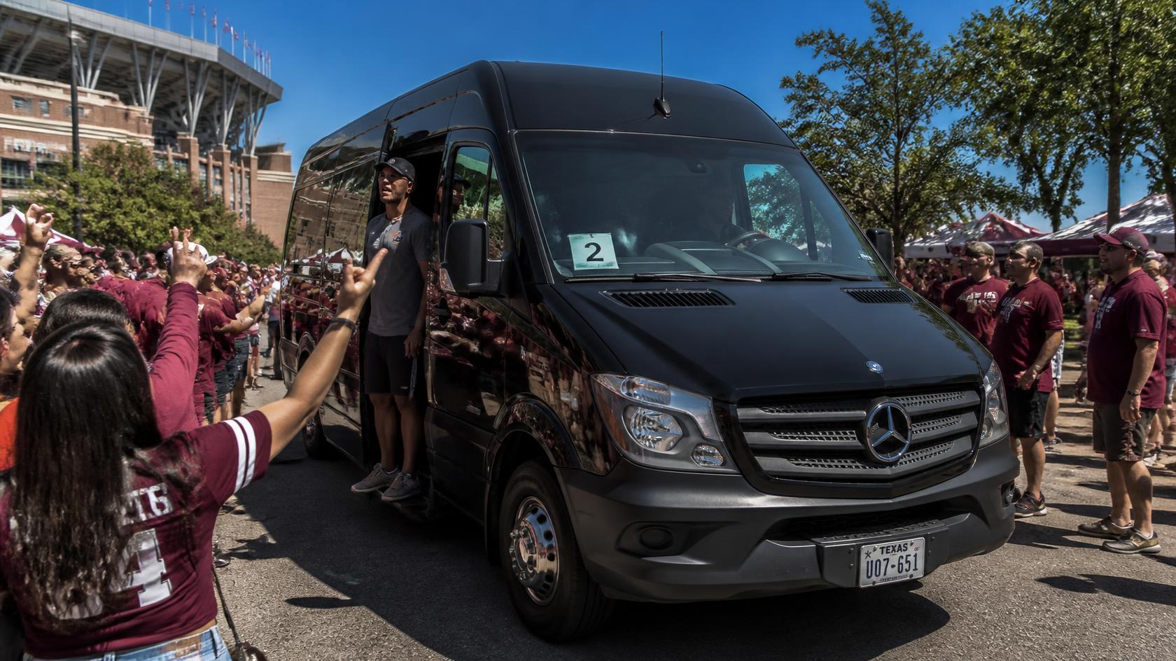 Sprinter van staged on the roadside near the Ravens stadium gates for group pickup after a game